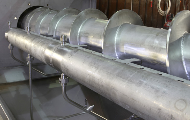 Stainless steel screw conveyor flights and spray pipework during assembly