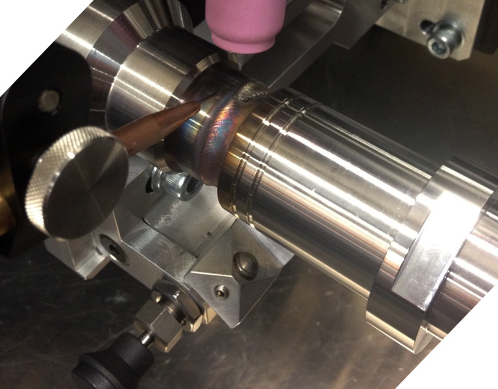 Machine TIG weld on a stainless steel coupling held in a welding lathe