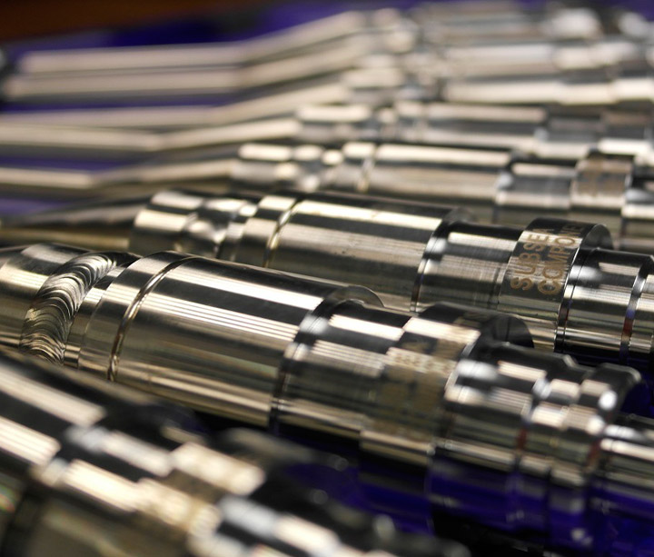 Machine-welded stainless steel components laid out in rows
