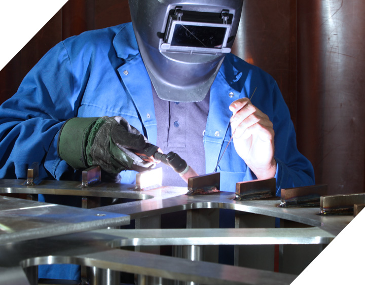 Welder TIG welding a stainless steel frame