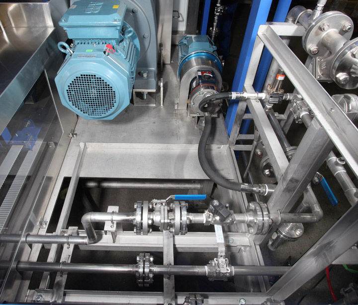 Stainless steel pipework, pump and motor on a process skid