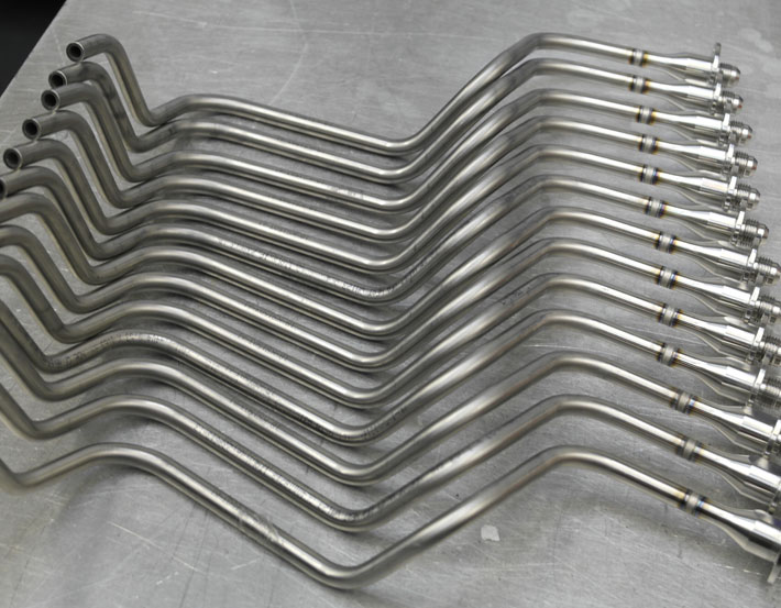 Batch of bent stainless steel tube assemblies with orbital-welded fittings